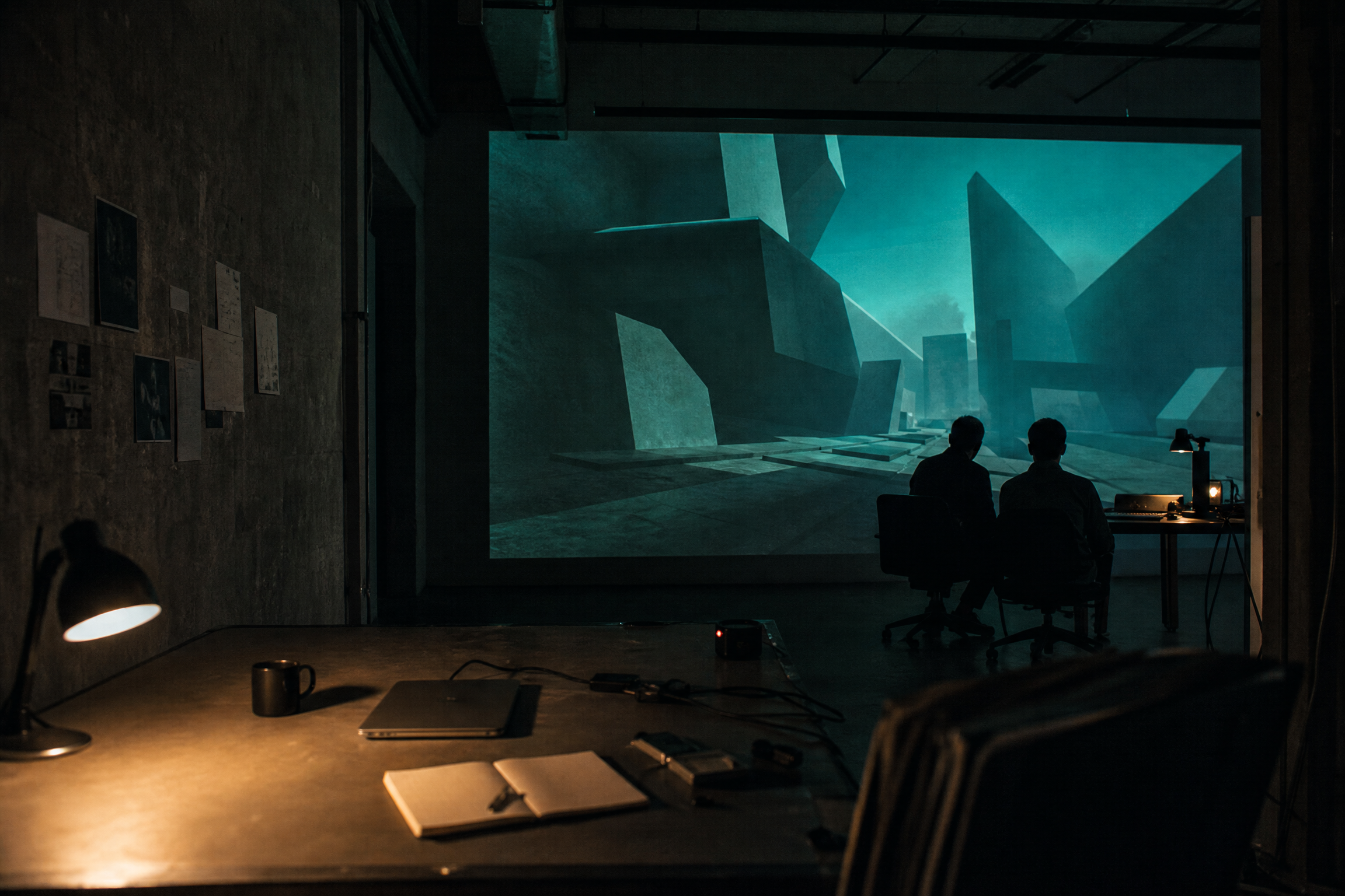 Quiet game playtesting space lit by an abstract projection